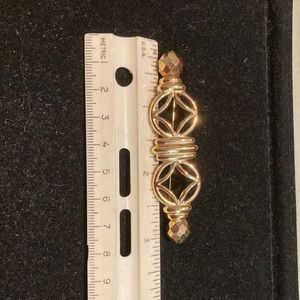 Gold tone open work bar pin. Givenchy.